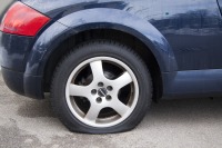 car with front left flat tire