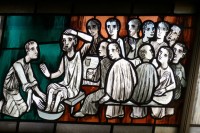 stain glass representation of jesus washing disciples feet