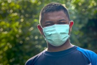 man in surgical mask from shoulders up