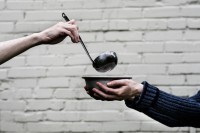 brick wall, ladle, hands holding bowl